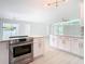 Modern white kitchen with stainless steel appliances and a spacious island at 161 Overbrook W St, Largo, FL 33770