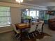 Bright dining area with a modern table, chairs, and natural light streaming through the windows at 5 158Th Ave, Redington Beach, FL 33708