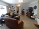 Comfortable living room with large sectional, recliner, shelving, and a neutral color palette at 5 158Th Ave, Redington Beach, FL 33708