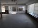 Sunlit living room with sliding doors and extensive water damage at 5 158Th Ave, Redington Beach, FL 33708