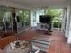 Enclosed sun room featuring natural light, workout equipment, and sliding glass doors at 5 158Th Ave, Redington Beach, FL 33708