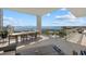 Spacious covered balcony with a table and chairs offering beautiful water views at 540 N Tamiami Trl # 1702, Sarasota, FL 34236