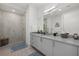 A pristine bathroom featuring a glass enclosed shower and sleek white vanity at 540 N Tamiami Trl # 1702, Sarasota, FL 34236
