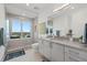 Bright bathroom featuring a glass-enclosed shower and spacious vanity with sleek countertops at 540 N Tamiami Trl # 1702, Sarasota, FL 34236