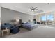 Serene bedroom with gray walls, a ceiling fan and access to a private balcony at 540 N Tamiami Trl # 1702, Sarasota, FL 34236