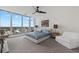 Sun-filled bedroom with floor-to-ceiling windows showcasing city views and plush modern furnishings at 540 N Tamiami Trl # 1702, Sarasota, FL 34236