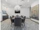 Refined conference room includes large table, modern chandelier, gray chairs and large format art pieces at 540 N Tamiami Trl # 1702, Sarasota, FL 34236