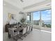Dining area with modern light fixture and floor to ceiling windows boasting water views at 540 N Tamiami Trl # 1702, Sarasota, FL 34236