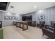 Well-lit game room with ample seating, TV, and light wood floors perfect for entertaining at 540 N Tamiami Trl # 1702, Sarasota, FL 34236