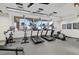 Well-equipped fitness center features treadmills, ellipticals, and weight machines, with palm tree views at 540 N Tamiami Trl # 1702, Sarasota, FL 34236