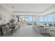 Bright, open-concept living area features stunning water views and modern furnishings at 540 N Tamiami Trl # 1702, Sarasota, FL 34236