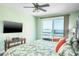 Spacious bedroom with water views and a large TV at 7 Island Park Pl # 304, Dunedin, FL 34698