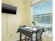 Small dining area with black table and chairs near a window at 7 Island Park Pl # 304, Dunedin, FL 34698