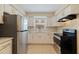 Updated kitchen with stainless steel appliances and white cabinets at 5733 66Th N Ln, St Petersburg, FL 33709