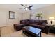 Living room with L-shaped sectional sofa and ceiling fan at 5733 66Th N Ln, St Petersburg, FL 33709