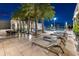 Expansive pool deck with lounge chairs and palm trees at 540 N Tamiami Trl # 1702, Sarasota, FL 34236