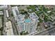 Aerial view showcasing a high-rise building with a rooftop pool at 540 N Tamiami Trl # 1702, Sarasota, FL 34236