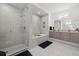 Spa-like bathroom with walk-in shower, soaking tub, and modern vanity at 540 N Tamiami Trl # 1702, Sarasota, FL 34236
