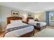 Well-lit bedroom featuring two double beds with wood frames at 36750 Us Highway 19 N # 15305, Palm Harbor, FL 34684