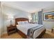 King size bed, nightstand, and artwork in a relaxing bedroom at 36750 Us Highway 19 N # 15305, Palm Harbor, FL 34684