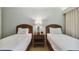 Two twin beds, with nightstands and lamps in a well-lit bedroom at 36750 Us Highway 19 N # 15305, Palm Harbor, FL 34684