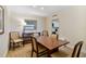 Condo dining area with table and chairs and view into kitchen at 36750 Us Highway 19 N # 15305, Palm Harbor, FL 34684