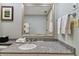 Bathroom features granite countertop, sink, and large mirror at 36750 Us Highway 19 N # 15305, Palm Harbor, FL 34684