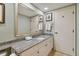 Bathroom featuring a granite countertop vanity and a large mirror at 36750 Us Highway 19 N # 15305, Palm Harbor, FL 34684