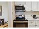 Modern kitchen with stainless steel appliances and white cabinets at 36750 Us Highway 19 N # 15305, Palm Harbor, FL 34684