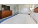 Bedroom with a dresser, TV, and comfortable bed at 36750 Us Highway 19 N # 15305, Palm Harbor, FL 34684