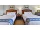 Two beds in a well-lit bedroom with nightstands at 36750 Us Highway 19 N # 15305, Palm Harbor, FL 34684