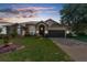 Attractive one-story home with a landscaped lawn and brick driveway at 5199 Panther Dr, Spring Hill, FL 34607