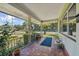 Covered porch with view of the street and palm trees at 7979 Garden N Dr, St Petersburg, FL 33710