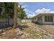 Large backyard with a wooden fence, brick patio, and grassy area at 7979 Garden N Dr, St Petersburg, FL 33710