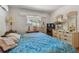 Bedroom with a patterned comforter and wood floors at 7979 Garden N Dr, St Petersburg, FL 33710