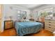 Bedroom with blue comforter and wood floors at 7979 Garden N Dr, St Petersburg, FL 33710