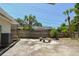 Backyard with concrete patio, wooden fence, and stone benches at 7979 Garden N Dr, St Petersburg, FL 33710