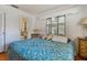 Bedroom with blue comforter and access to bathroom at 7979 Garden N Dr, St Petersburg, FL 33710