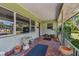 Front porch with terracotta tile floor and potted plants at 7979 Garden N Dr, St Petersburg, FL 33710