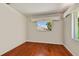 Simple bedroom, featuring hardwood floors and a window at 7979 Garden N Dr, St Petersburg, FL 33710