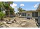 Backyard patio with stone benches and partial view of house at 7979 Garden N Dr, St Petersburg, FL 33710