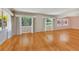 Bright living room with hardwood floors and stained-glass windows at 7979 Garden N Dr, St Petersburg, FL 33710