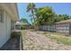 Backyard view showing a partially grassy yard with trees and a fence at 7979 Garden N Dr, St Petersburg, FL 33710