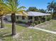 Single-story home with a covered porch and lush landscaping at 7979 Garden N Dr, St Petersburg, FL 33710