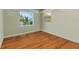 Empty bedroom with hardwood floors and two windows at 7979 Garden N Dr, St Petersburg, FL 33710