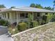 Charming single story home with a covered porch and well-manicured landscaping at 7979 Garden N Dr, St Petersburg, FL 33710