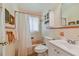 Clean bathroom with a tub, shower, and updated vanity at 7979 Garden N Dr, St Petersburg, FL 33710