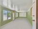 Bright living room with light green walls and neutral carpeting at 7979 Garden N Dr, St Petersburg, FL 33710