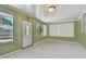 Spacious living room featuring a white door and large windows at 7979 Garden N Dr, St Petersburg, FL 33710