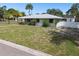 House with a large front yard and a white fence at 7979 Garden N Dr, St Petersburg, FL 33710